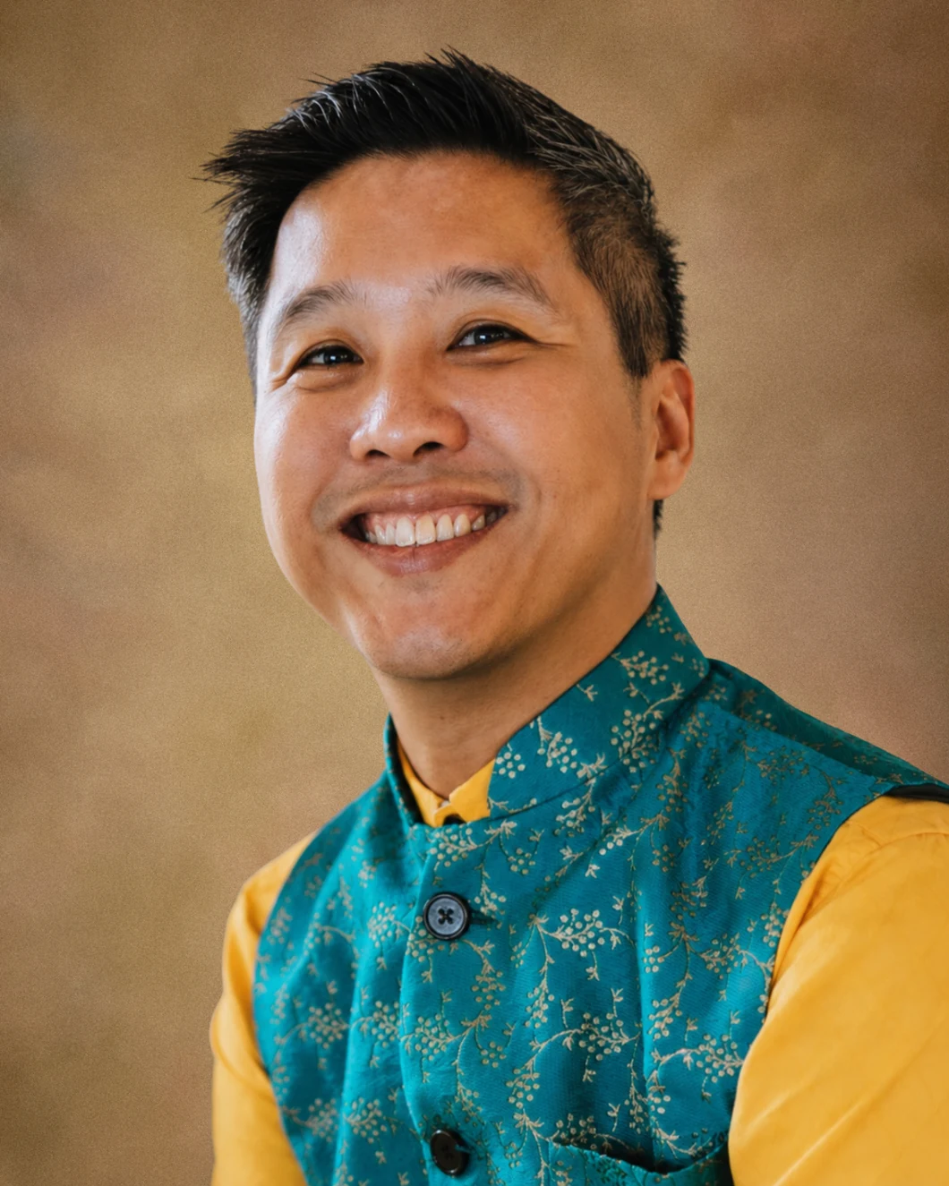 Portrait of Ray in a teal patterned vest