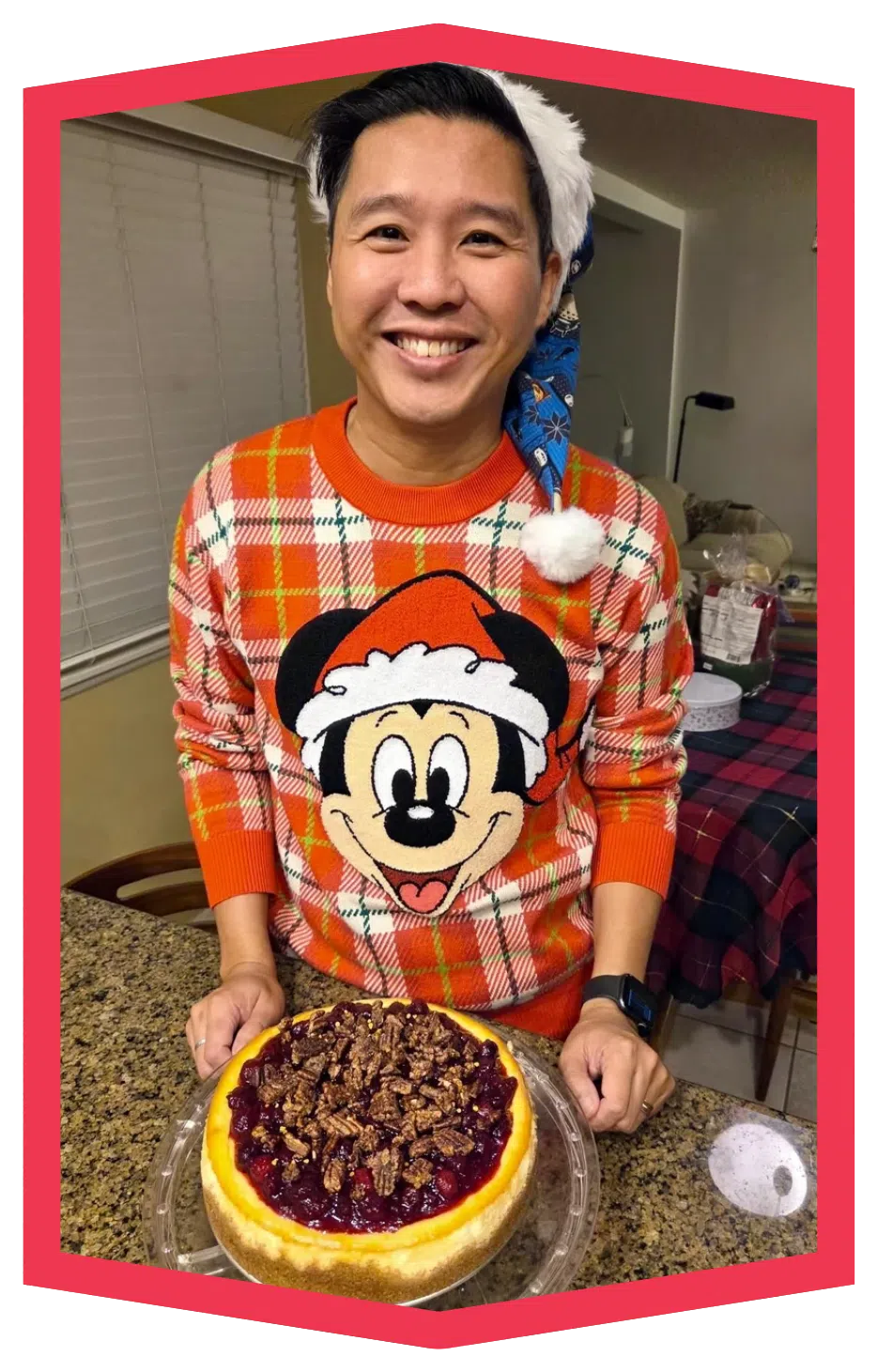 Ray holding a cheesecake, framed in pink